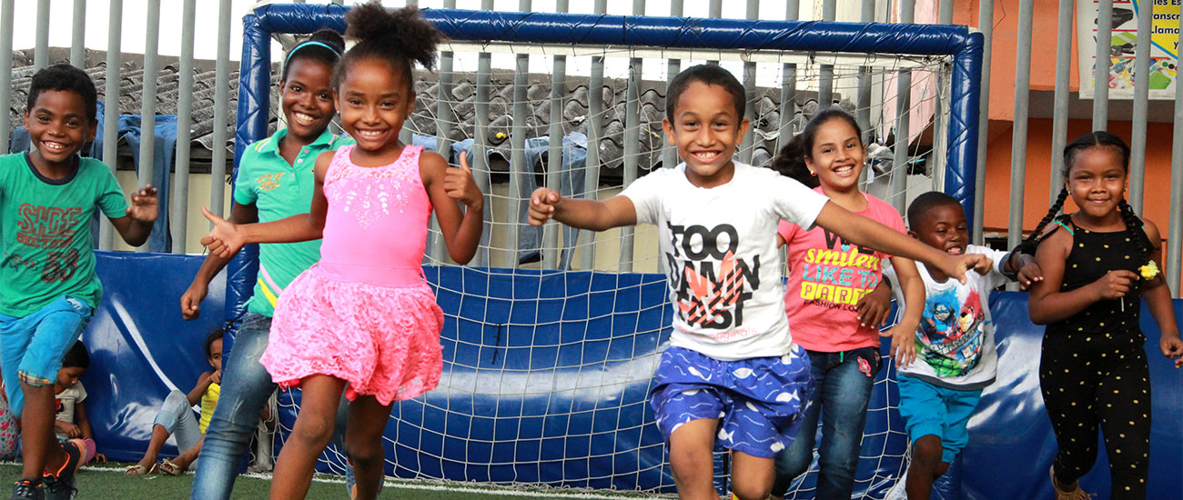 a group of young children playing a game of soccer