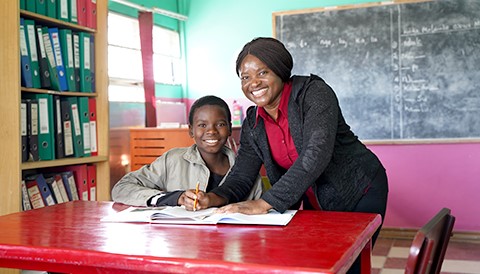 a child and a woman in a Community Center library