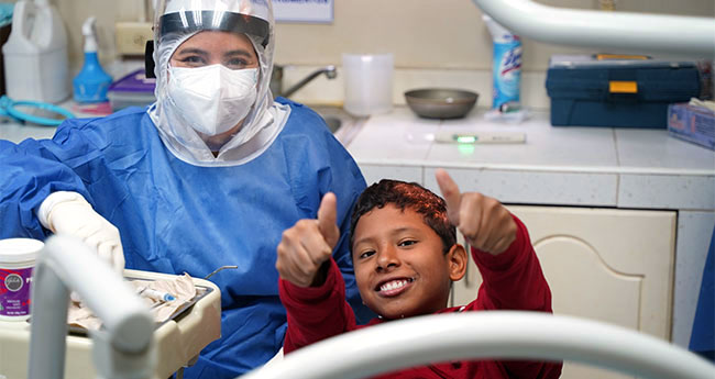 a woman and a child in a dentist's chair