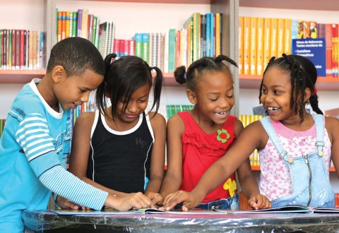Kids read books at a community center